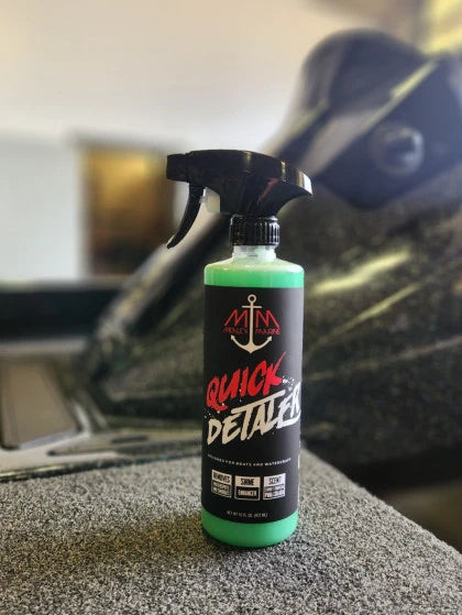 Mealey Marine Quick Detailer spray bottle sitting not he front deck of a boat. 